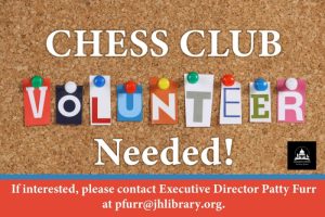 Chess club volunteer graphic. Volunteer spelled out on multicolored paper and pinned to cork board.