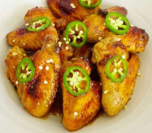 Coca-Cola Glazed Wings topped th jalapeno pepper slices and seeds