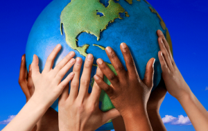 multicultural hands holding up globe