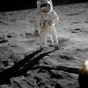 astronaut facing forward while walking on the moon
