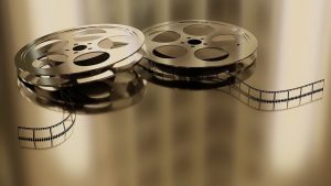 two unraveled movie reels on shiny table