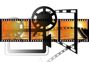 illustration of movie projector silhouette and film with ocean sunsets in each frame